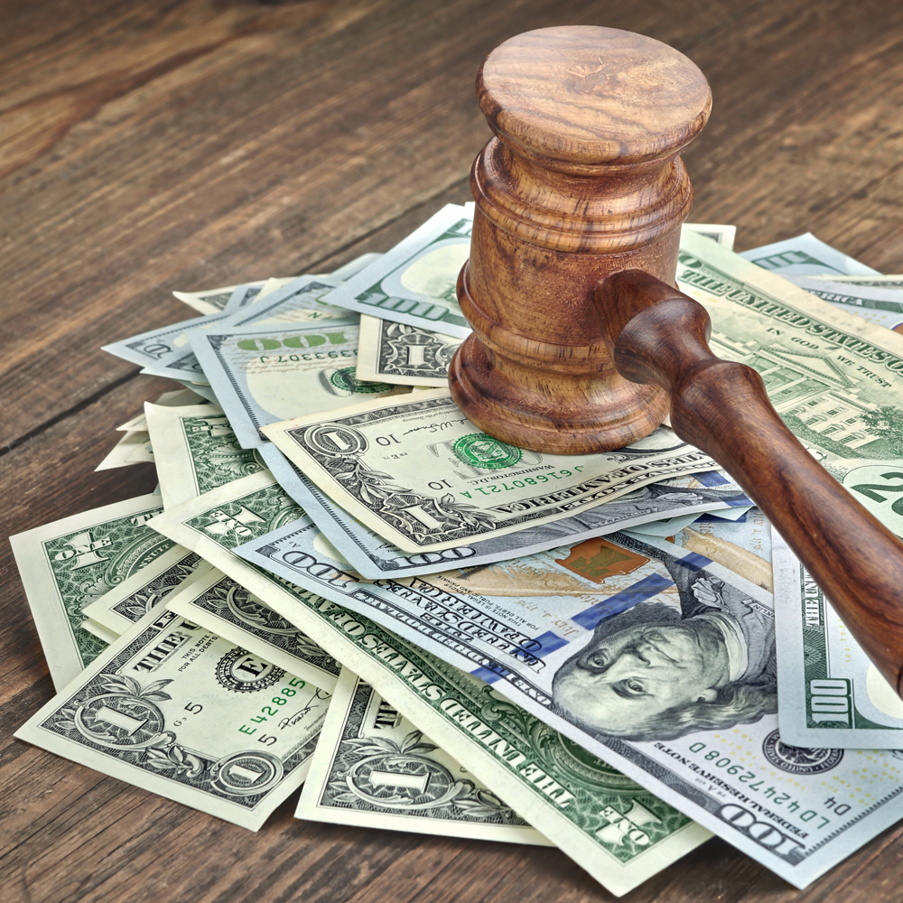 Stack Of Banknotes With Judges Or Auctioneers Gavel Or Hammer